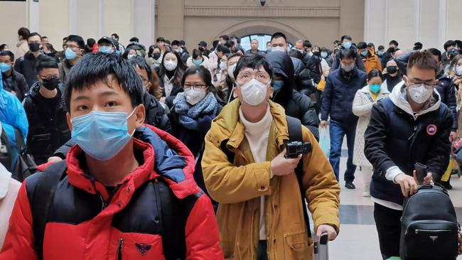 People wear face masks as they wait at Hankou Railway Station in Wuhan. Picture: Getty