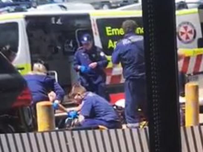 Paramedics at work in the carpark, next to Hawi’s car.