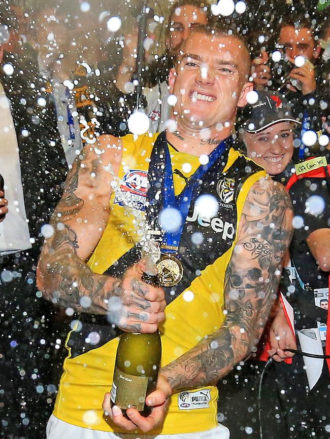 Dustin Martin pops the champagne. Picture: Mark Stewart