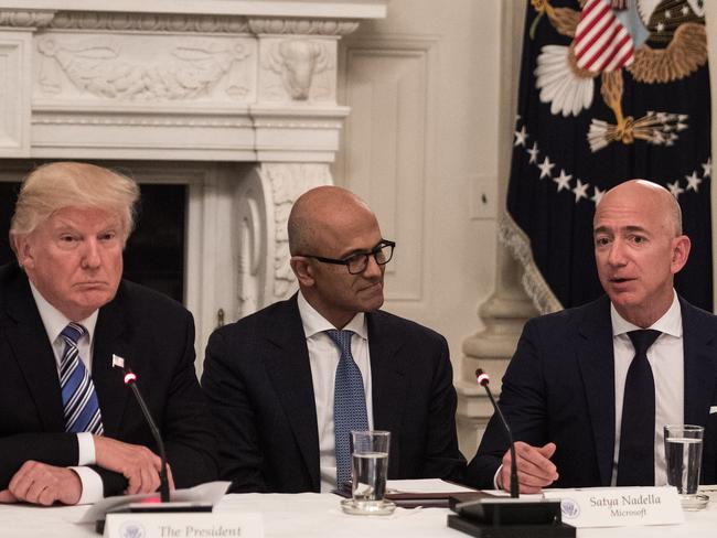 US President Donald Trump (L) and Microsoft CEO Satya Nadella (C) as they listen to Amazon CEO Jeff Bezos (R). Picture: AFP