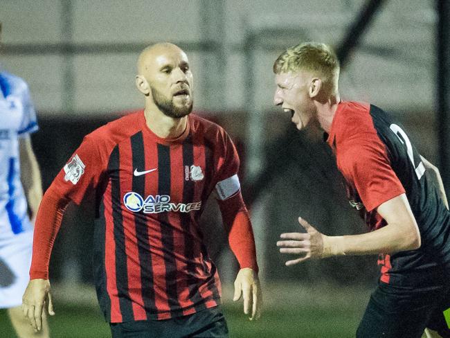 Burleigh Heads captain Matt Hilton (left) celebrates his opening goal in Saturday night’s Gold Coast Premier League grand final against Surfers Paradise. Picture: Ryan Kazmer/East End Digital