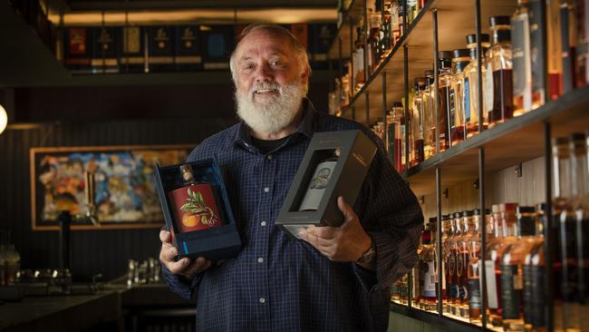 Lark Distillery founder Bill lark holds the Lark Limited Release Chinotto Cask II Cask Strength Single Malt Whisky and the Lark Symphony No.1 Blended Malt Whisky at The Still, Hobart. Picture: Chris Kidd