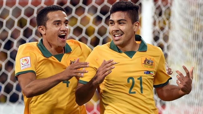 Australia's Massimo Luongo (R) is congratulated by teammate Tim Cahill (L) after scoring against Kuwait during the opening football match of the AFC Asian Cup in Melbourne on January 9, 2015. AFP PHOTO / William WEST --IMAGE RESTRICTED TO EDITORIAL USE - STRICTLY NO COMMERCIAL USE--