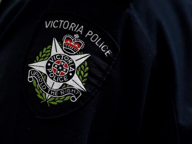 A Victorian Police badge is seen as approximately 275 kilograms of crystal methamphetamine is displayed at the Australian Federal Police offices in Melbourne, Monday, July, 4, 2016. A Victoria Joint Organised Crime Task Force (JOCTF) seized the methamphetamine with a street value of $275 million after identifying the syndicate in February, arresting one Malaysian and seven Australians. This is the biggest seizure in Victoria this year. (AAP Image/Tracey Nearmy) NO ARCHIVING