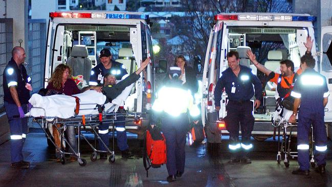 09/05/2006. Miners Todd Russell (right) and Brant Webb celebrate their arrival at the Launceston General Hospital. The two miners were trapped 1km underground for 13 and 1/2 days at the Beaconsfield gold mine after a rock fall on April 25. (AAP Image/Dale Cumming) NO ARCHIVING