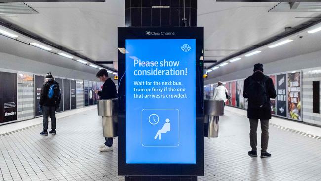 A sign reading 'Please show consideration! Wait for the next bus, train or ferry if the one that arrives is crowded' is pictured at Stockhom Central metro station, amid the ongoing coronavirus pandemic. Picture: AFP