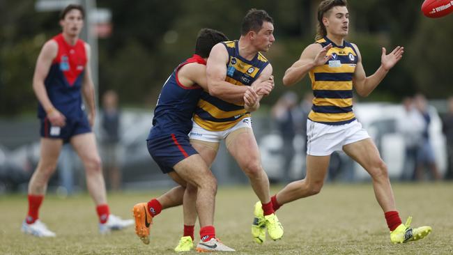 Old Melburnians stalwart Thomas Paule handballing against Old Brighton in a previous meeting. Picture: Valeriu Campan