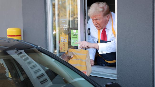 Donald Trump works the drive-through line at McDonald’s. Picture: Getty Images via AFP.