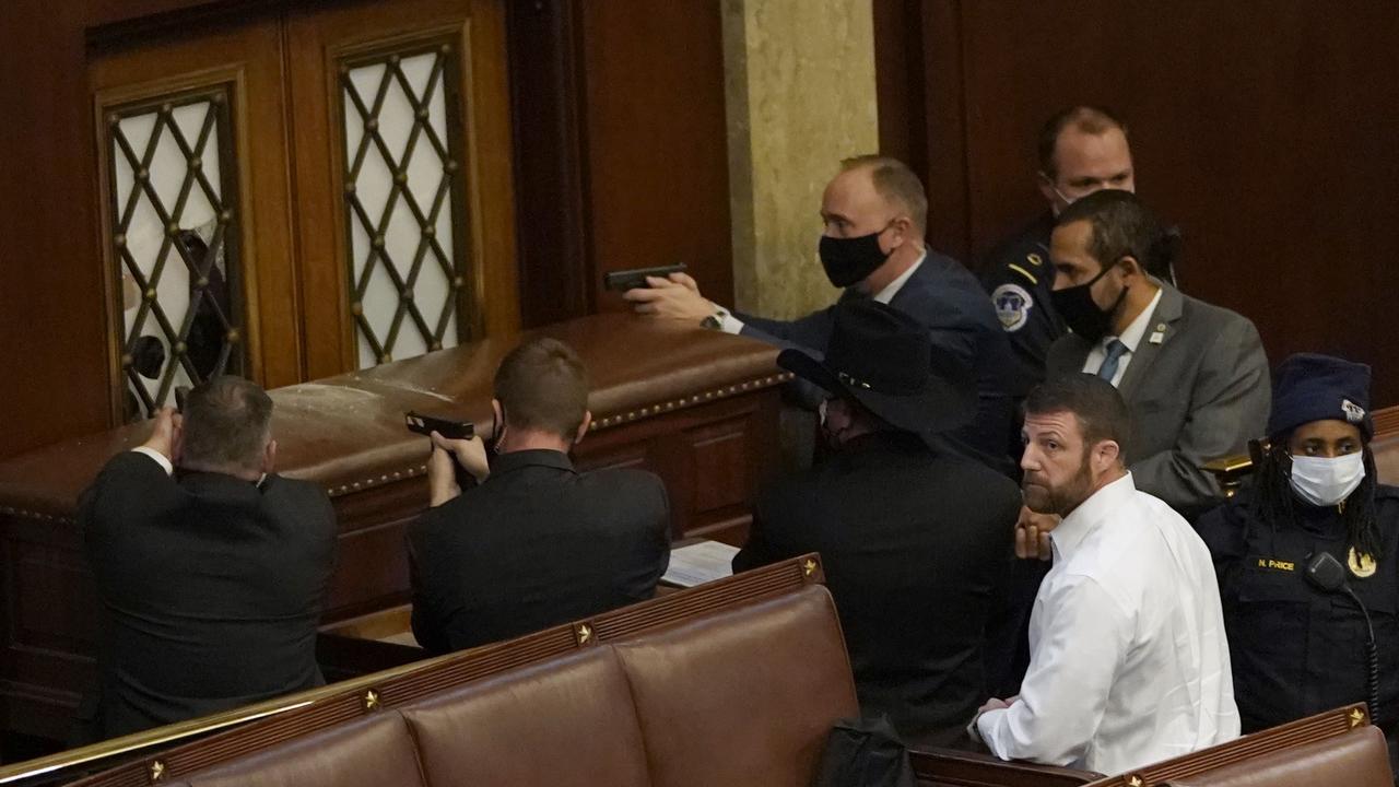 Capitol police officers point their guns during violent clashes with protesters. Picture: Drew Angerer/Getty Images/AFP