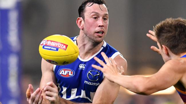 Todd Goldstein (left) of the Kangaroos handballs over the top of Zac Bailey (right) of the Lions during the Round 18 AFL match between the Brisbane Lions and the North Melbourne Kangaroos at the Gabba in Brisbane, Saturday, July 20, 2019.  (AAP Image/Darren England) NO ARCHIVING, EDITORIAL USE ONLY