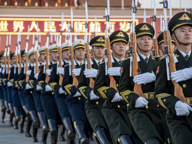 The Guard of Honor of the Chinese People's Liberation Army (PLA) escorts the national flag during a flag-raising ceremony at the Tian'anmen Square. Picture: VCG/VCG via Getty Images