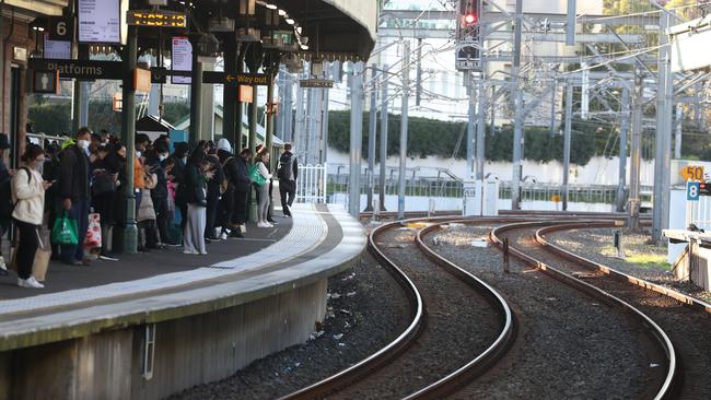 Platforms grew with passengers at Strathfield train station as a message overhead warned trains will be late. Picture: John Grainger