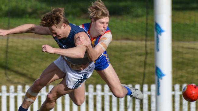 Henley’s Bailey Klemasz is tackled by Old Ignatians’ Will Ferrari in their Adelaide Footy League division two clash on Saturday. Picture: Brenton Edwards