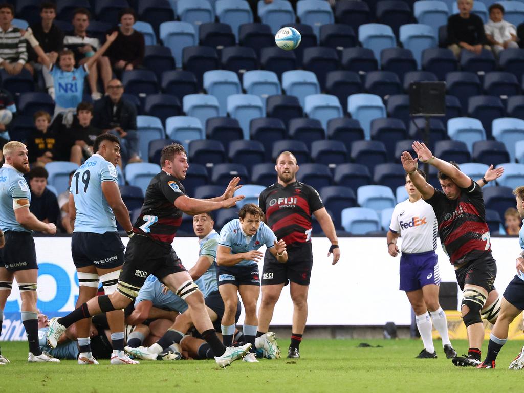 Will Harrison’s under heavy pressure as he fired his drop goal attempt towards the uprights. Picture: AFP