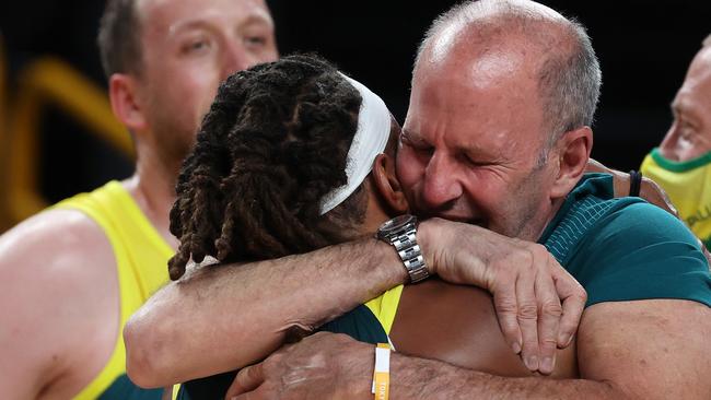 Brian Goorjian gives man of the moment Patty Mills a huge hug after winning the bronze.