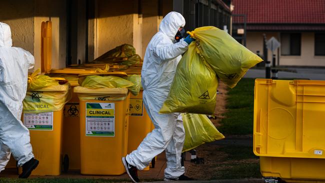 Workers removing items from the nursing home during the outbreak. Picture: Jason Edwards