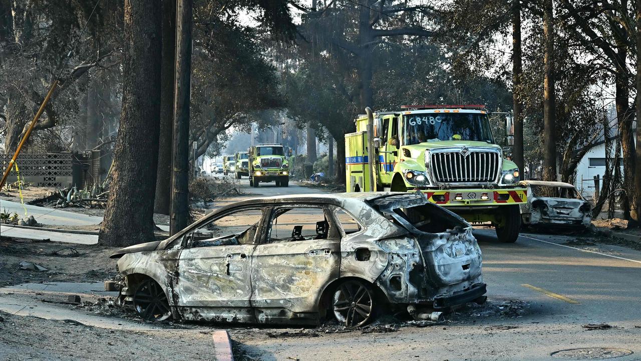 Firefighters travel through destruction left by the bushfires that have engulfed whole neighbourhoods in Los Angeles. Picture: AFP