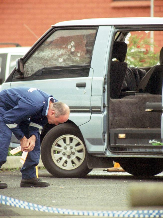 Forensic police examine the scene.