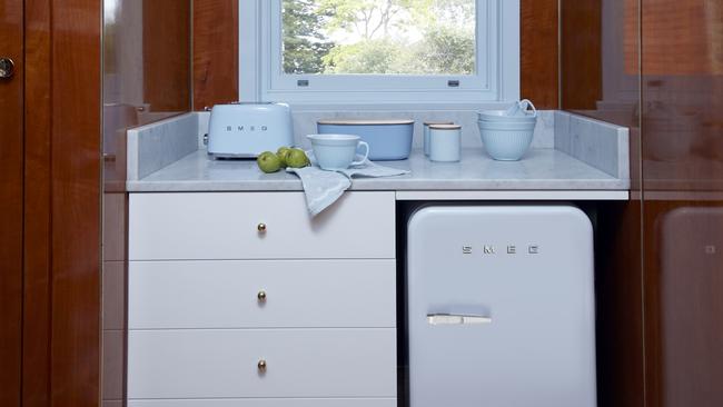 The walk-in pantry hosts extra storage and a bar fridge