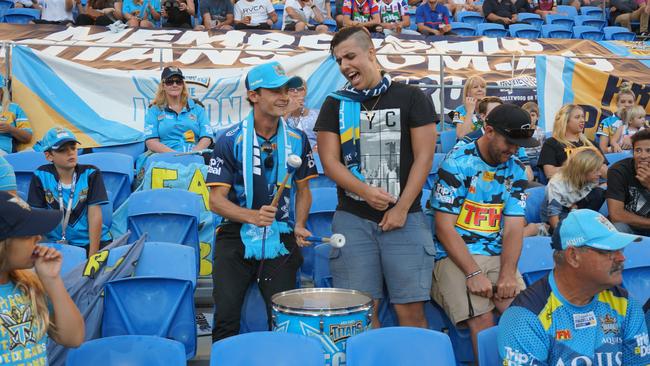 Gold Coast Bulletin reporter Connor O'Brien, on drums, ventures into the Titans fan group The Legion at Cbus Super Stadium. Also pictured are Legion member Blaze Ross and Dan Meyer. Photo: supplied