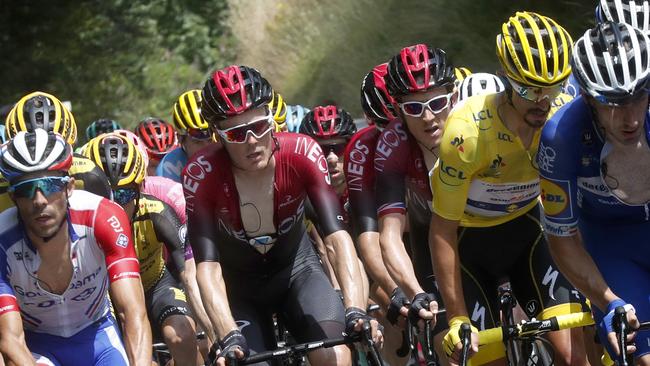 France's Julian Alaphilippe wearing the overall leader's yellow jersey rides in the pack with Britain's Geraint Thomas, centre, right, and France's Thibaut Pinot, left. Picture: AP Photo/Thibault Camus