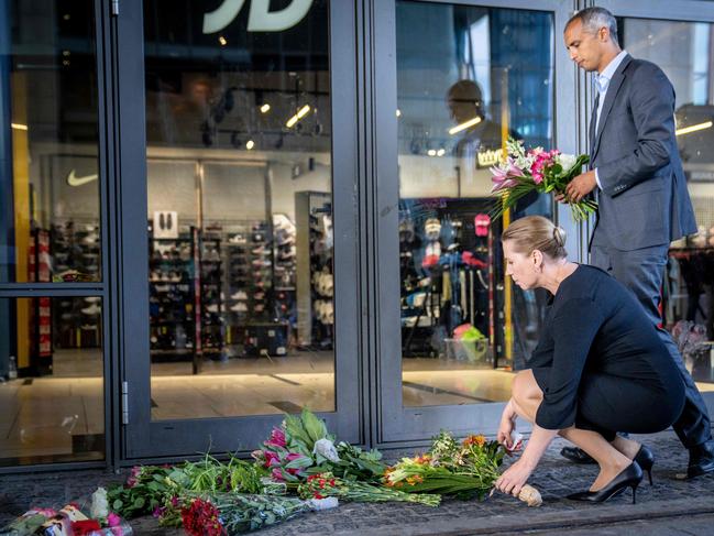 Danish Prime Minister Mette Frederiksen and Minister of Justice Mattias Tesfaye lay down flowers at a memorial as they visit the site of a shooting at Fields mall. Picture: AFP