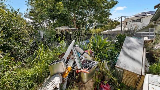 The yard at 62 Blaker Road, Mitchelton, is filled with junk.