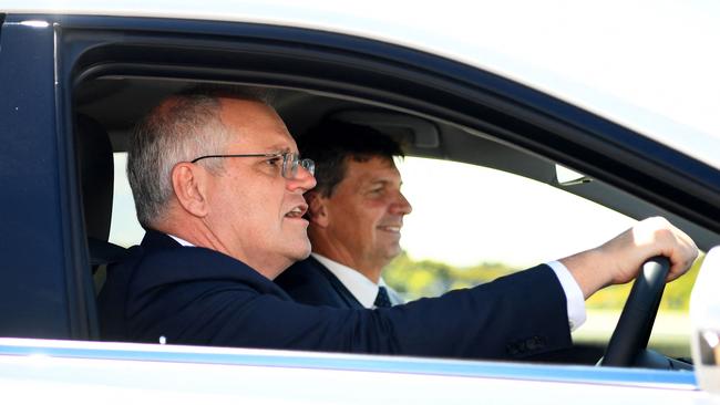 Scott Morrison, left, and Angus Taylor in a hydrogen-powered car at the Toyota test track in Melbourne on Tuesday. Picture: AFP