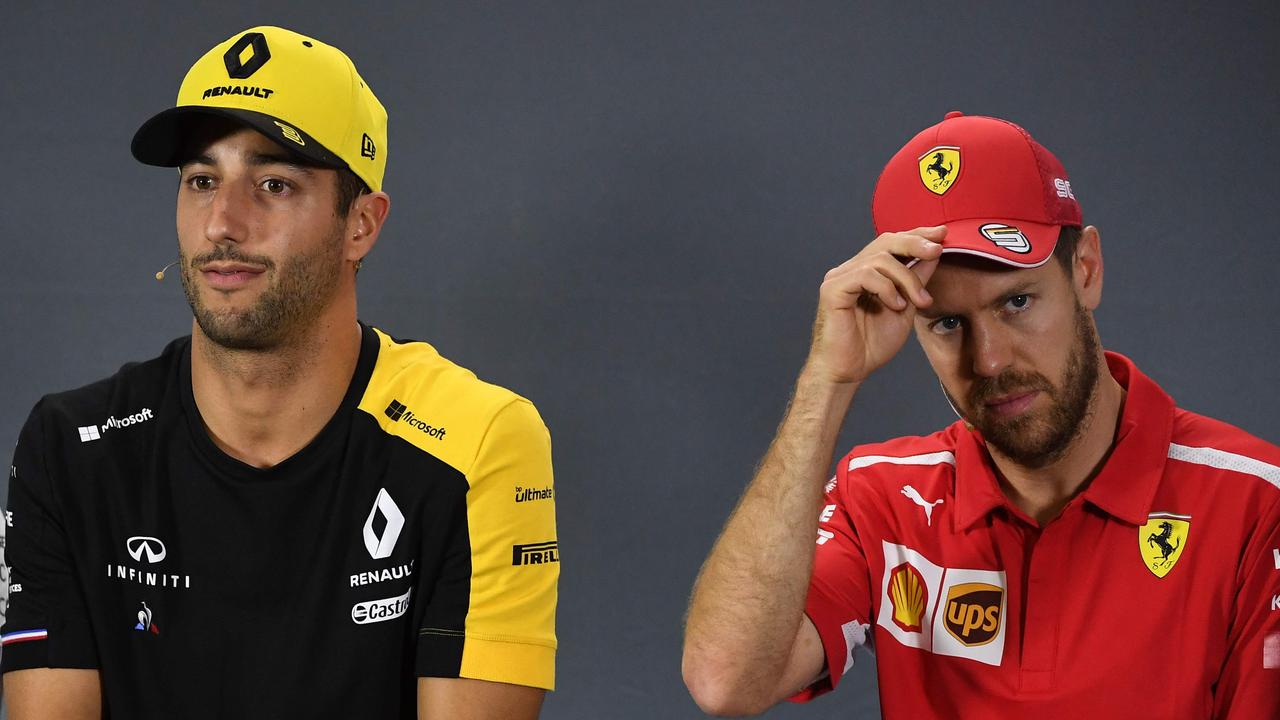 Daniel Ricciardo and Sebastian Vettel went in different directions in 2014. (Photo by William WEST / AFP)