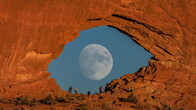 The resulting image of the full moon seen passing across the arch has had several thousands of likes. Picture: Caters/@zachcooleyphoto