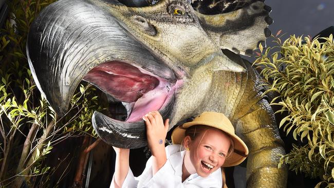 Bridie McCauley gets up close to a dinosaur at Docklands. Jurassic Creatures, featuring Prehistoric Creatures of the Ice is an interactive walk through event that will captivate young and old alike. Explore an ancient world full of moving dinosaurs at Docklands Open at Harbour Town Melbourne from 12 March to 17 April.Picture:Rob Leeson.