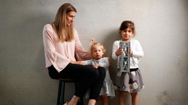 Rocket scientist Flavia Tata Nardini with her children Vittoria, 2, and Caterina, 4, playing with a satellite at her warehouse in Beverley. Picture: Matt Turner