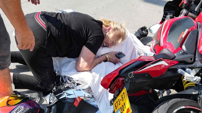 A woman weeps over the covered corpse of her nephew who was shot dead in the southern city of Sderot. Picture: AFP