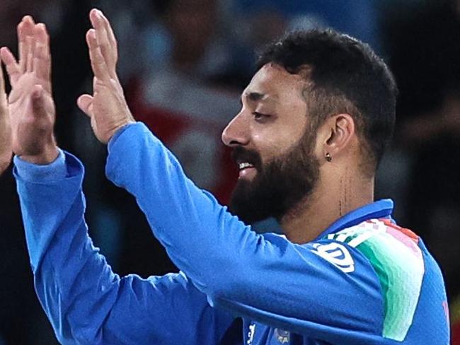 India's Varun Chakravarthy (R) celebrates with teammate Hardik Pandya after taking the wicket of New Zealand's Matt Henry during the ICC Champions Trophy one-day international (ODI) cricket match between New Zealand and India at the Dubai International Stadium in Dubai on March 2, 2025. (Photo by FADEL SENNA / AFP)