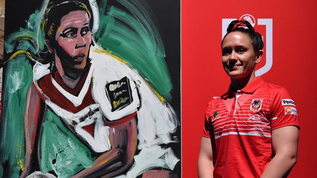 St George-Illawarra Dragons new recruit Brittany Breayley poses for a photo with a mural of herself during the NRL Women's Premiership season launch.