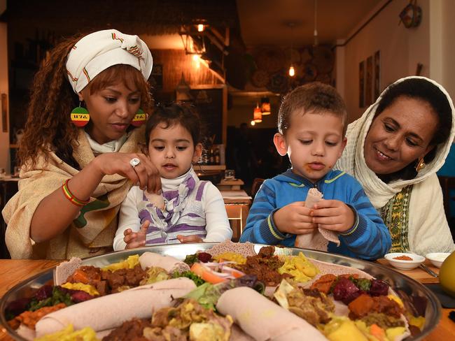 Heaven Taye, with Page, Zac and mother Tsige Kiros at Mesob Restaurant in Northcote. Picture: David Smith