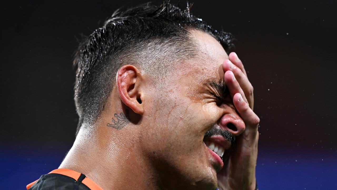 Jayden Sullivan of the Wests Tigers wipes his face during the round five NRL match between Dolphins and Wests Tigers at Suncorp Stadium, on April 06, 2024, in Brisbane, Australia. (Photo by Bradley Kanaris/Getty Images)