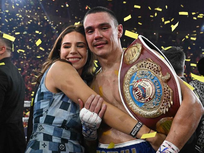 Australian boxer Tim Tszyu (R) celebrates with his partner Alexandra Constantine following his victory over USA's Tony Harrison in their WBO super welterweight world title bout at Qudos Bank Arena in Sydney on March 12, 2023. (Photo by Saeed KHAN / AFP) / -- IMAGE RESTRICTED TO EDITORIAL USE - STRICTLY NO COMMERCIAL USE --