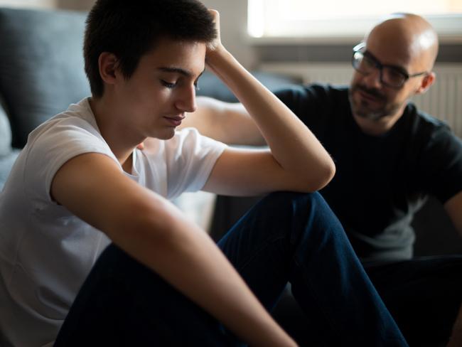 Upset young man talking with his father.