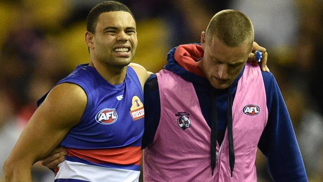 Jason Johannisen leaves the field with a hamstring injury. Picture: AAP