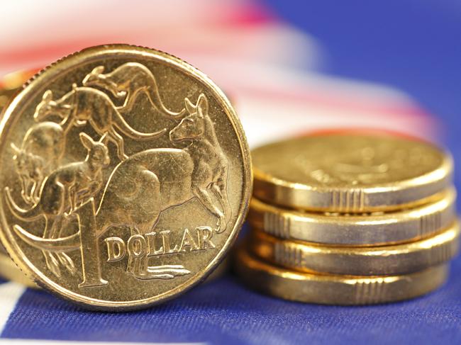 Australian coins sitting on an Australian flag. money coins dollars generic