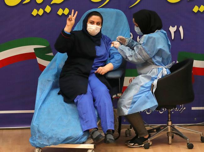 Iranian health worker Sara Gudarzi receives the COVID-19 vaccine as the country launched its inoculation campaign in Tehran. Picture: AFP