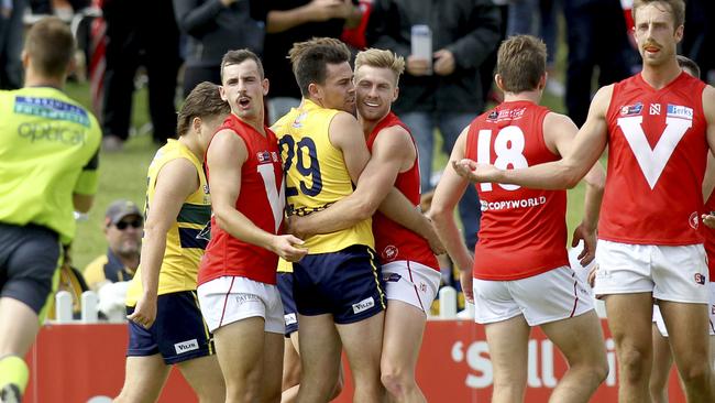 North's Alex Spina and Mitchell Clisby appeal for a free after wrapping up Eagle Matthew Goldsworthy. Picture: AAP Image/Dean Martin