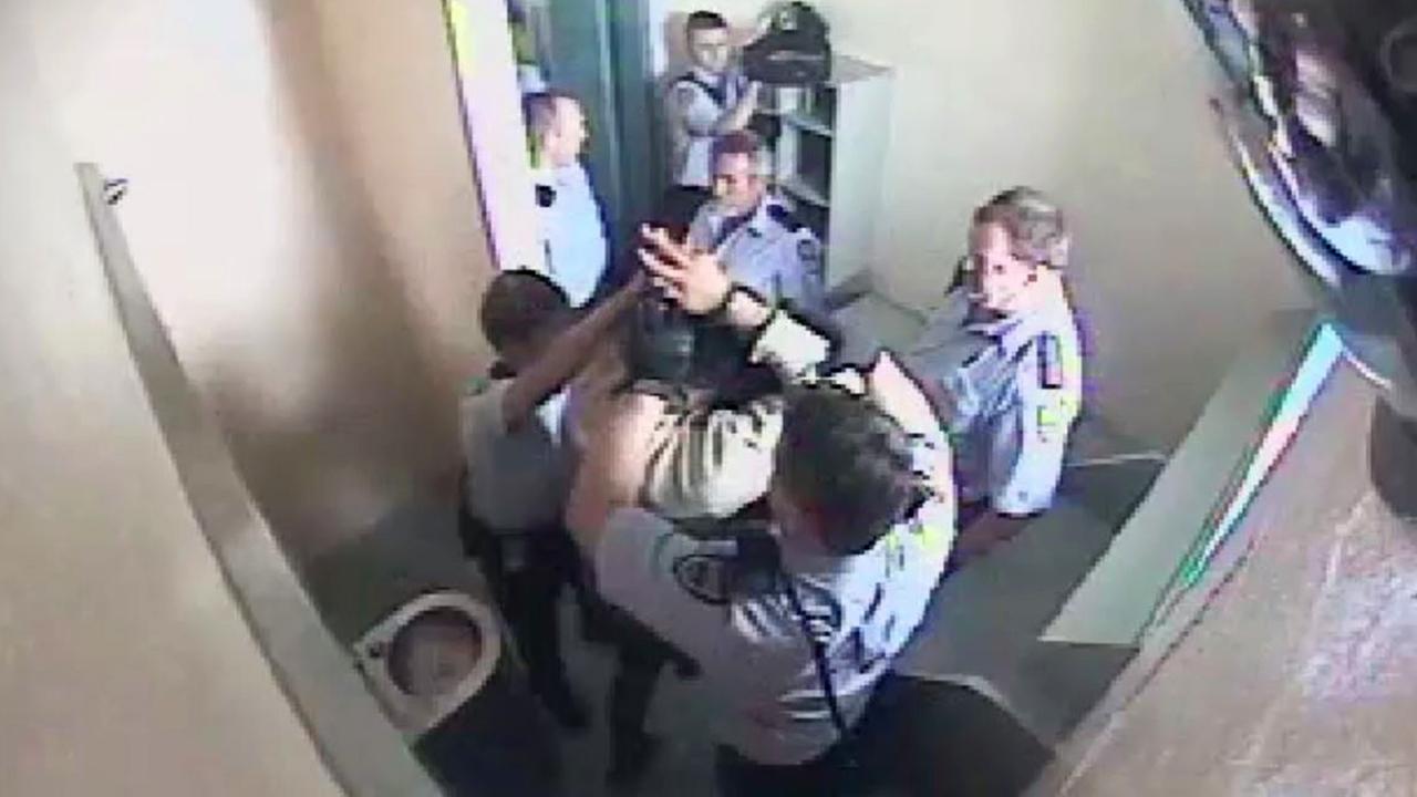 CCTV footage from Brisbane Correctional Centre of a 17 year-old old having restraints and a spit hood put on him.