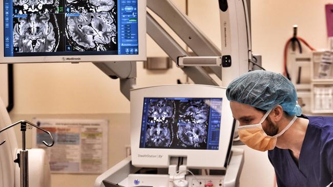 Bionics Institute biomedical engineer Nicholas Sinclair checks the recordings of brain activity for neurosurgeon Kristian Bulluss. Picture: Tony Gough