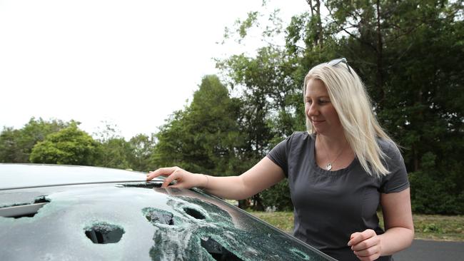 Clare O'Brien from Berowra Heights in Sydney showing damage to her car caused by December’s hailstorm. Picture: Tim Hunter.