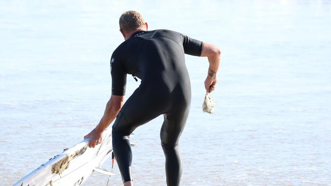 Mick Fanning with fish. Photo: Leisa Oakes @natures_jewel