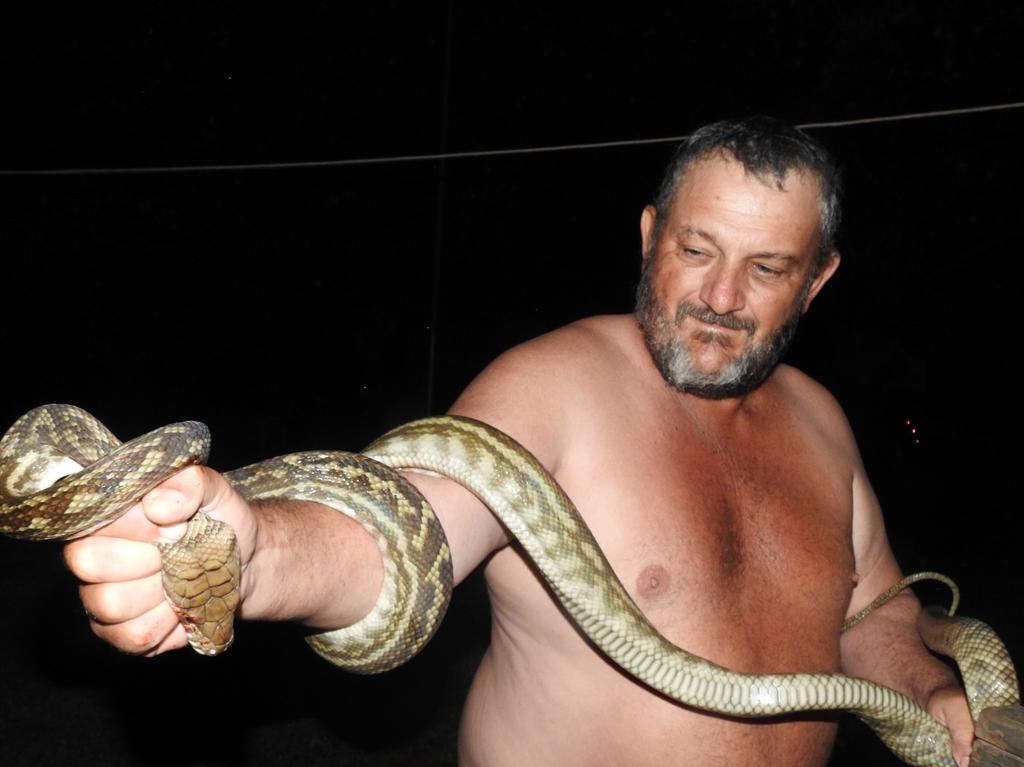 Nev Jackson with the snake that was wrapped around his son. Picture: Cairns Post