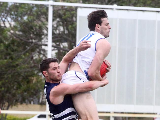 Round 2 QAFL Australian rules game between Broadbeach Cats and Mt Gravatt at Subaru Oval. Photo of Benjamin Hancock (left) and Andrew Smith (right). Photo by Richard Gosling.