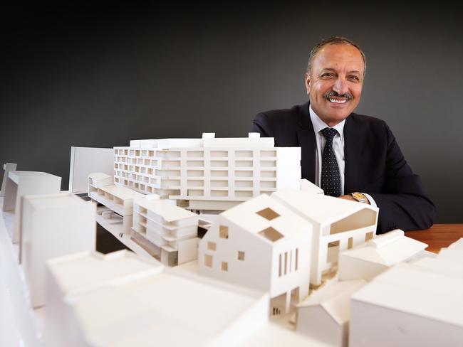 Ali Sultan with a scale model of the development.